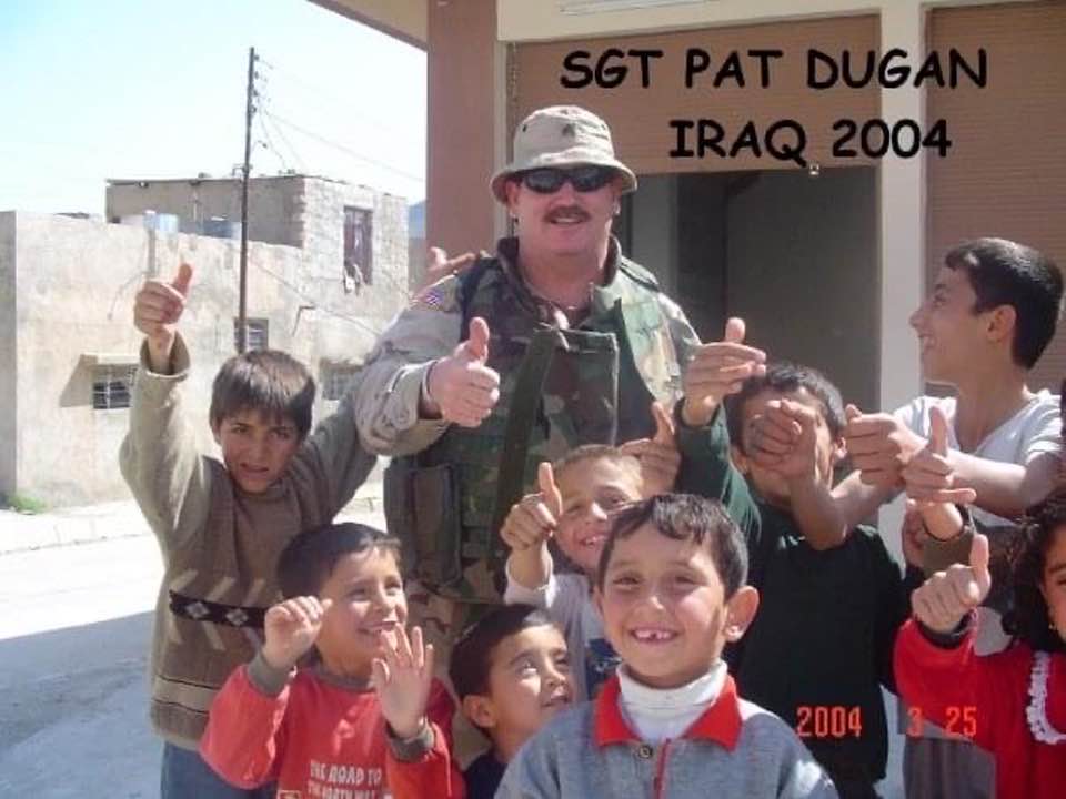 Pat with children in Iraq.jpg